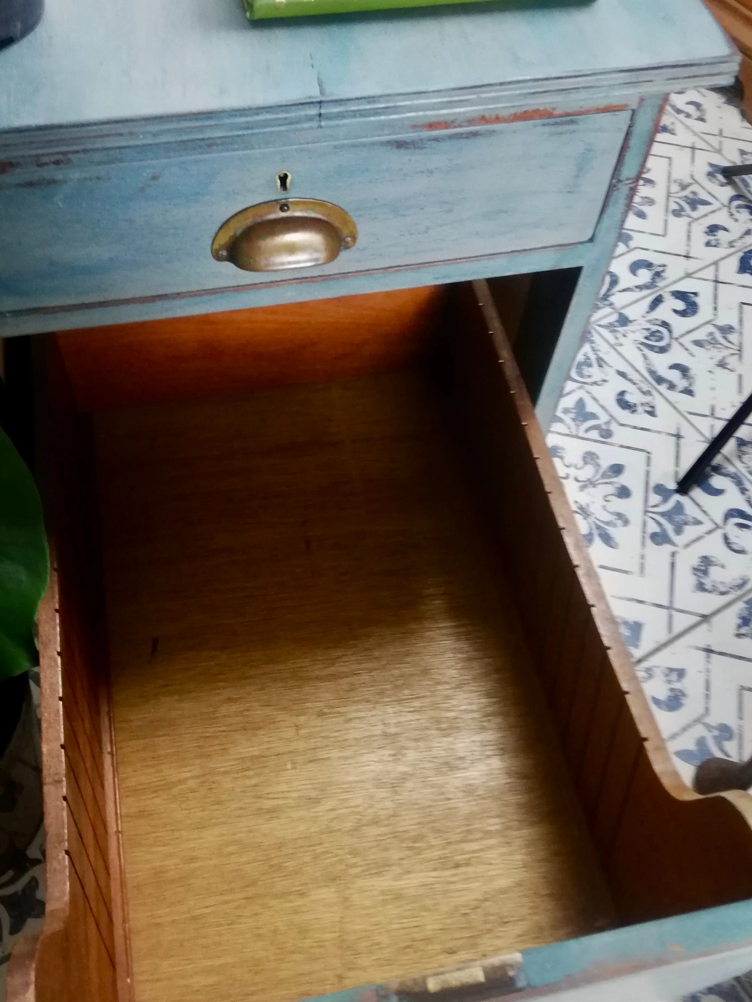 Vintage wooden filing cabinet painted in chippy layers of blue and grey.