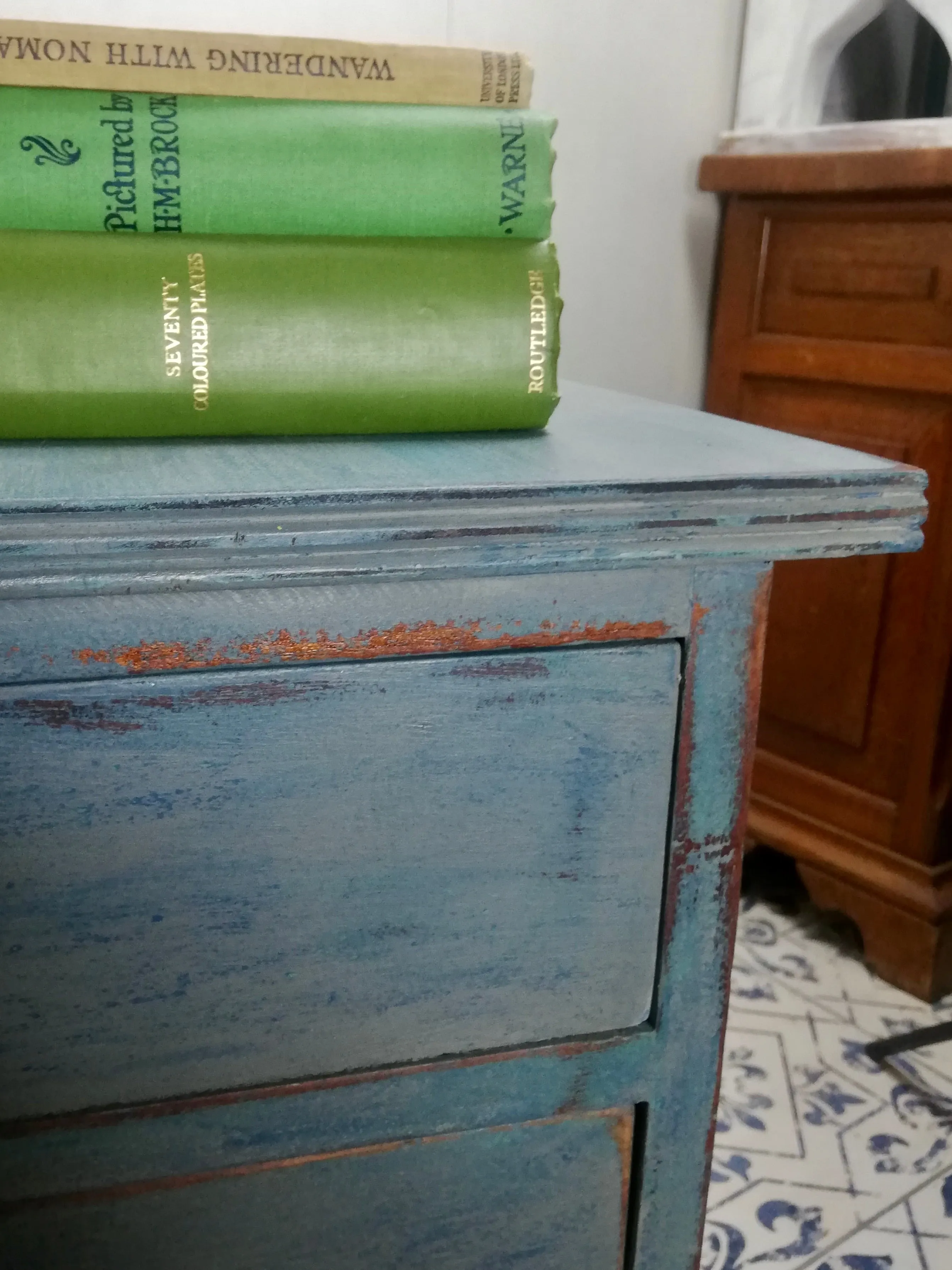 Vintage wooden filing cabinet painted in chippy layers of blue and grey.